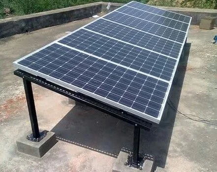 A solar panel mounted on a concrete slab in Alwar, Rajasthan, representing advancements in solar energy.